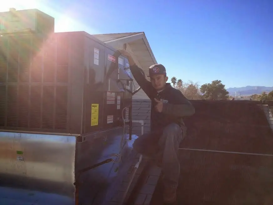 HVAC technician performing HVAC Inspection on a rooftop unit in Mount Holly